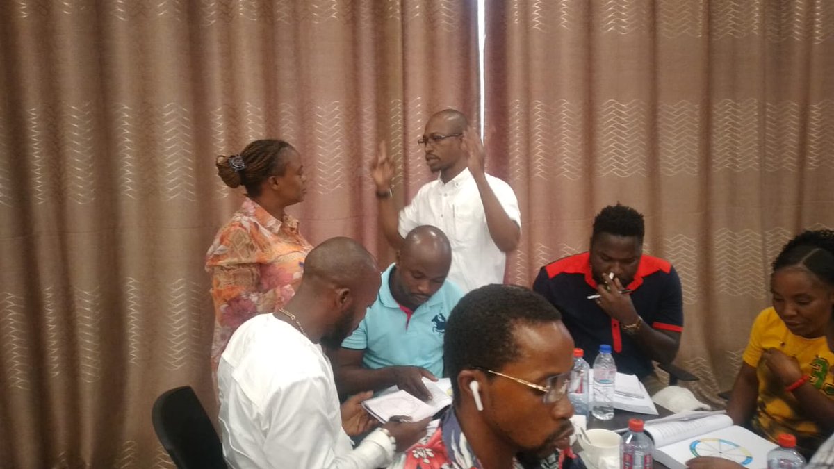 Day three of Universal Recovery Curriculum (URC) TOT on Drug Demand Reduction in Monrovia, Liberia with Trainer standing in white giving instructions for group work.