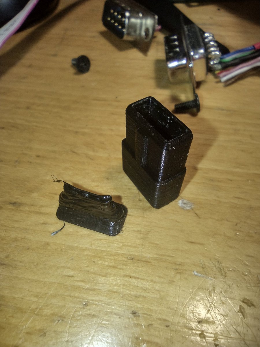3D printed HP 200LX serial connector shells. I tried to print flexible strain reliefs, but that did not work, I think layer times were too short for filament to cool off.
