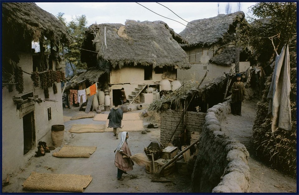 1978:-This scene depicts typical life in Kashmir. Houses were made of mud and timber with thatched roofs . Once, entire Kashmir periphery was looking like this but now quite a very few villages are retaining these structures. The houses used to be two-storied, in which the..(1/3)