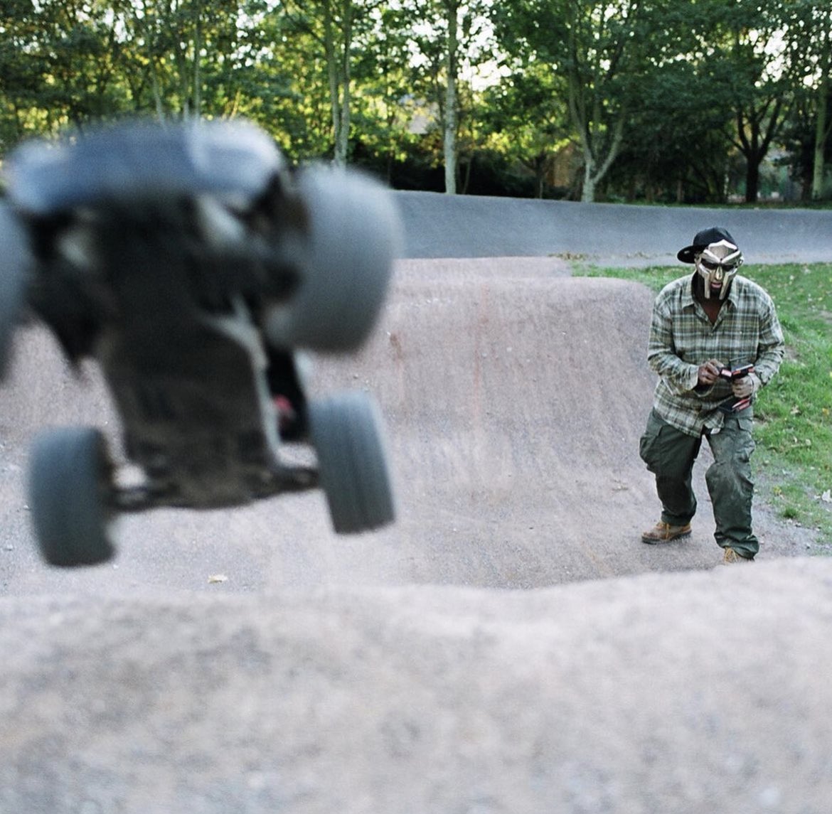 Grantpa23's tweet photo. MF DOOM photographed in Haggerston Park in 2012 w/ his son King Malachi 

📷: Alex De Mora https://t.co/m2zsA0N3Y6