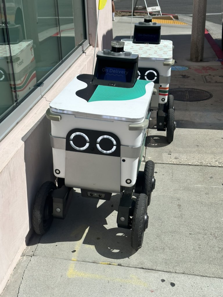 danacarvey's tweet photo. Robot delivery carts await instructions for the next delivery. 

Has the real life Jetsons arrived? https://t.co/O6Rw0E3ZFS