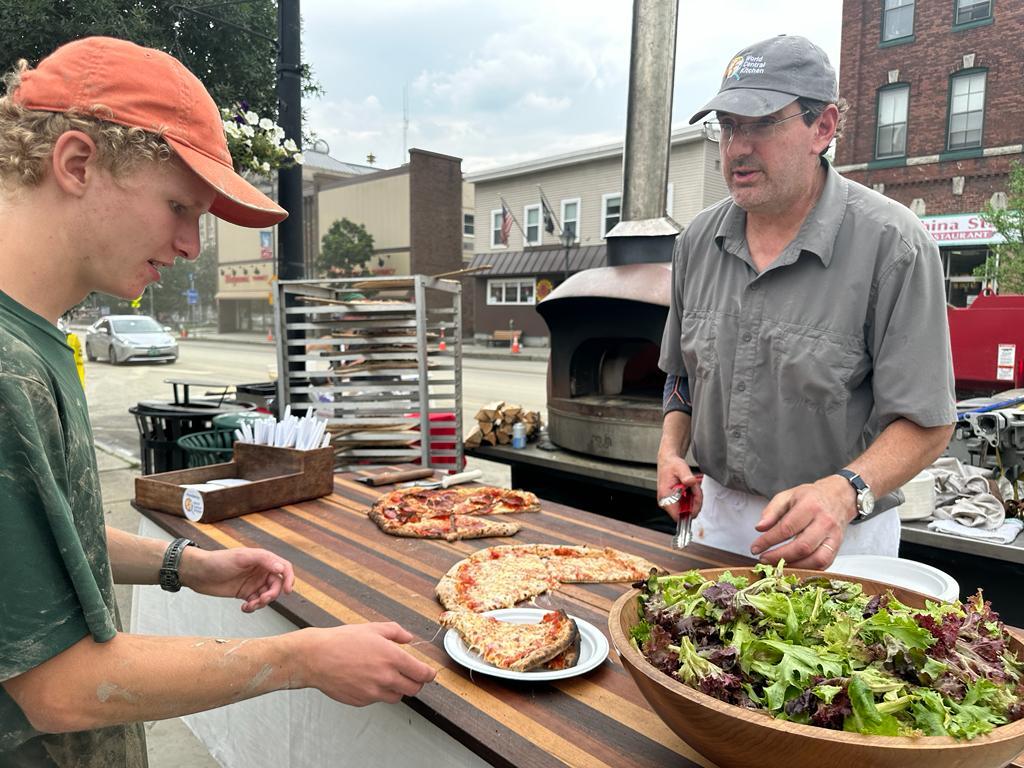 WCKitchen's tweet photo. Open Hearth Pizza set up its wood fired oven in downtown Montpelier today to support families impacted by this week’s catastrophic flooding. WCK is working with food trucks and restaurants throughout Vermont to ensure nourishing meals reach people in need. #ChefsForVermont https://t.co/gi1eJQ2D1n