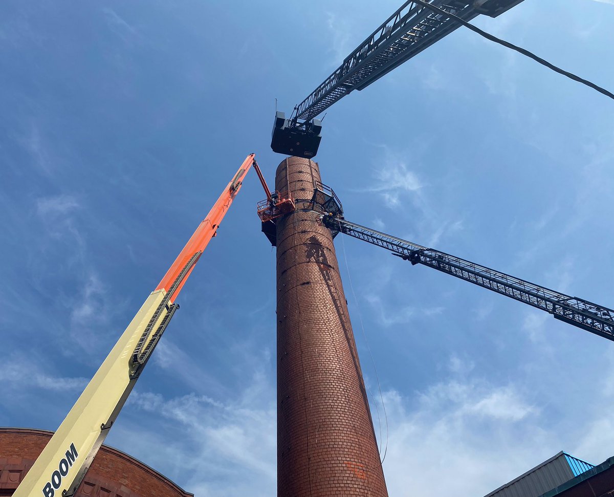 FraminghamFire's tweet photo. Today, we had a high angle rescue at 7 Bishop St. One 29 yr-old male construction worker was stuck ~100 ft in the air on a lift that got stuck on a railing being removed from the old Dennison smoke stack. Crews were eventually able to cut the bucket free after ~3 hrs on scene. https://t.co/KlAv3SM87u