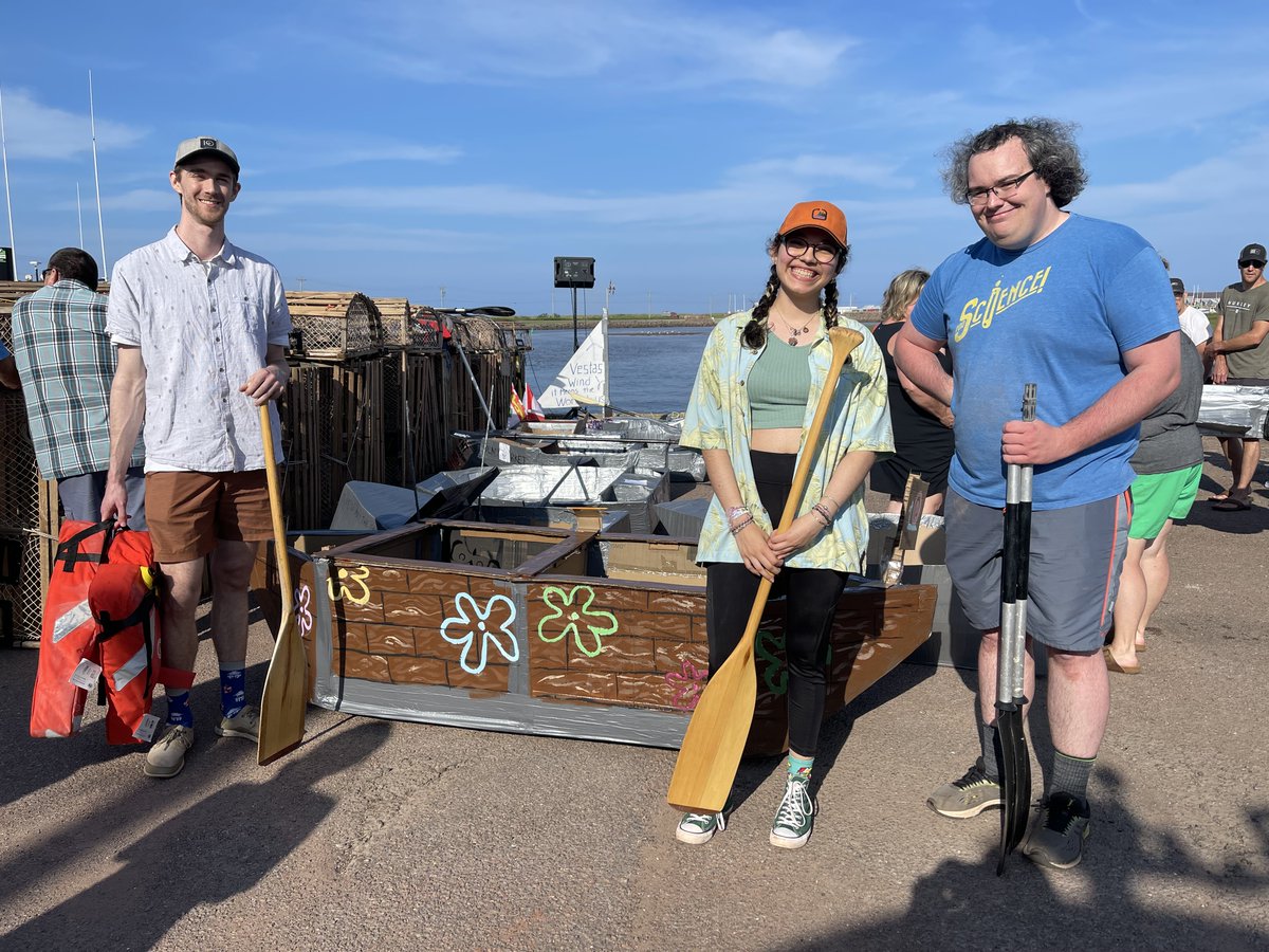 windenergycan's tweet photo. WEICan interns and students Amara Sánchez Cepeda, Trevor Coathup,  and Michael MacWilliam practised their Engineering and Physics skills  by taking part in the Tignish Irish Moss Festival Cardboard Boat Race.  They may not have won, but we give them high marks for design! https://t.co/MSITwaDrJl