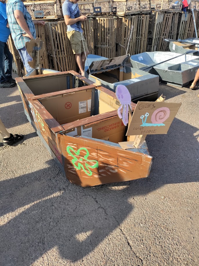windenergycan's tweet photo. WEICan interns and students Amara Sánchez Cepeda, Trevor Coathup,  and Michael MacWilliam practised their Engineering and Physics skills  by taking part in the Tignish Irish Moss Festival Cardboard Boat Race.  They may not have won, but we give them high marks for design! https://t.co/MSITwaDrJl