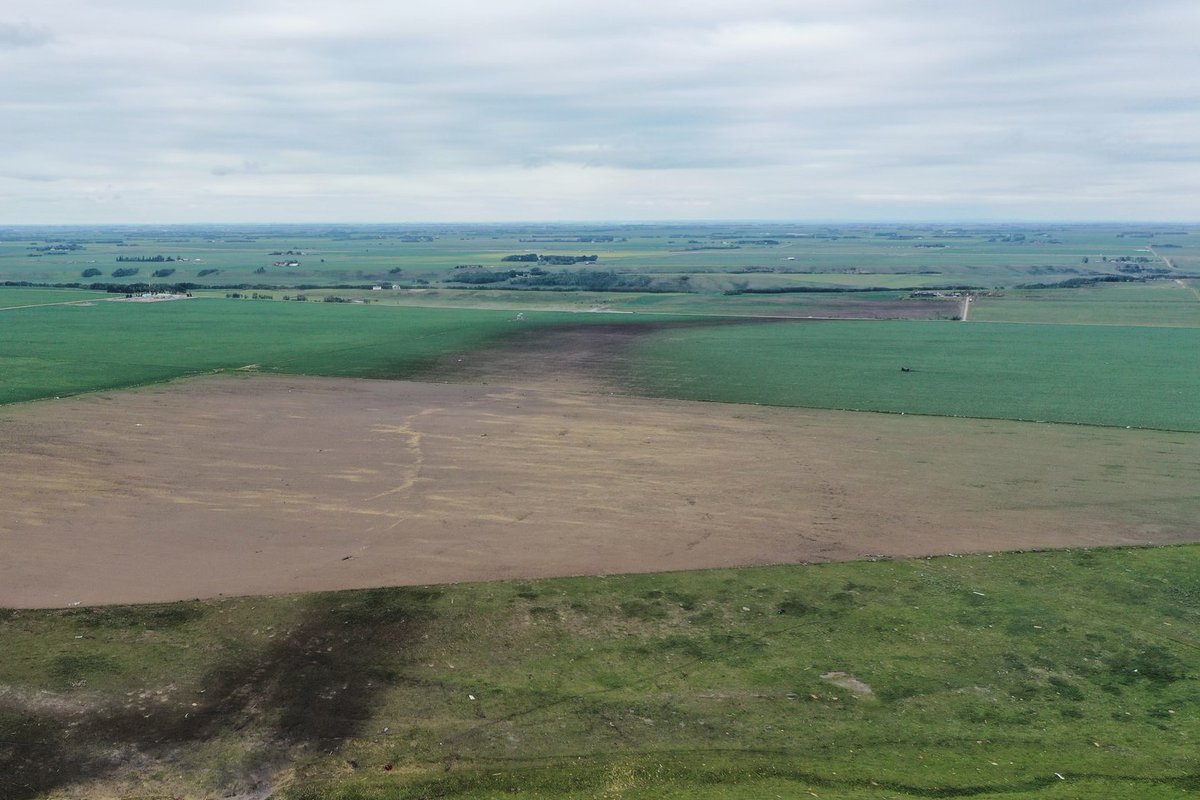 westernuNTP's tweet photo. Two NTP survey teams will be investigating the damage caused by a powerful tornado in the Didsbury, AB area  yesterday. An NTP team captured this image of the ground scour track going off into the distance last evening. 

They are coordinating with @ECCCWeatherAB who are also on the scene. #ABstorm