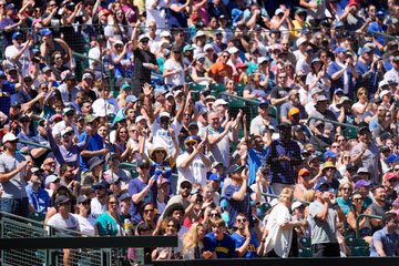 Photo of fans cheering after the Mariners win over the Rays. 