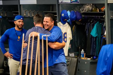 Luis Castillo receives hugs from his teammates. 