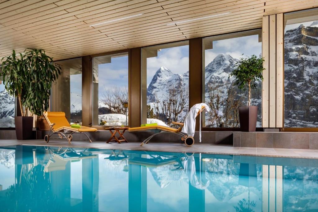 gregsostaric's tweet photo. @DPOURBABA Hotel Eiger (Murren, Switzerland), went during the end of ski season/Easter and my kids and I watched avalanches from the melting snow on the rock faces (miles away) from the hotels pool. https://t.co/kQF9fP3BCb