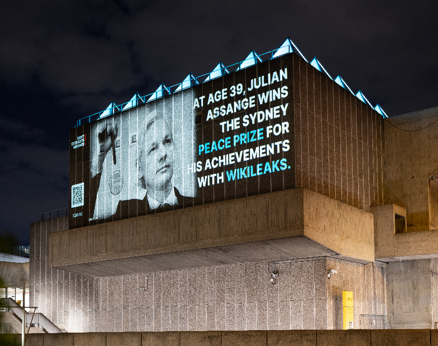 wikileaks's tweet photo. Projections around London call attention to the continued unjust detention of WikiLeaks publisher Julian Assange on the occasion of his 52nd Birthday today #FreeAssangeNOW #FreeAssangeNOW https://t.co/gX6ntnyvys