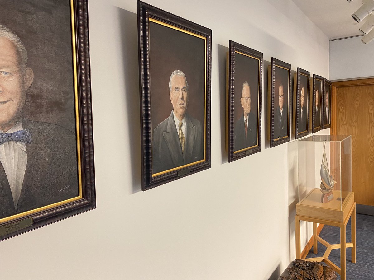 Official portraits of past IMO Secretary-Generals including Lt. Chandrika Prasad Srivastava in an institutional setting, 2023.