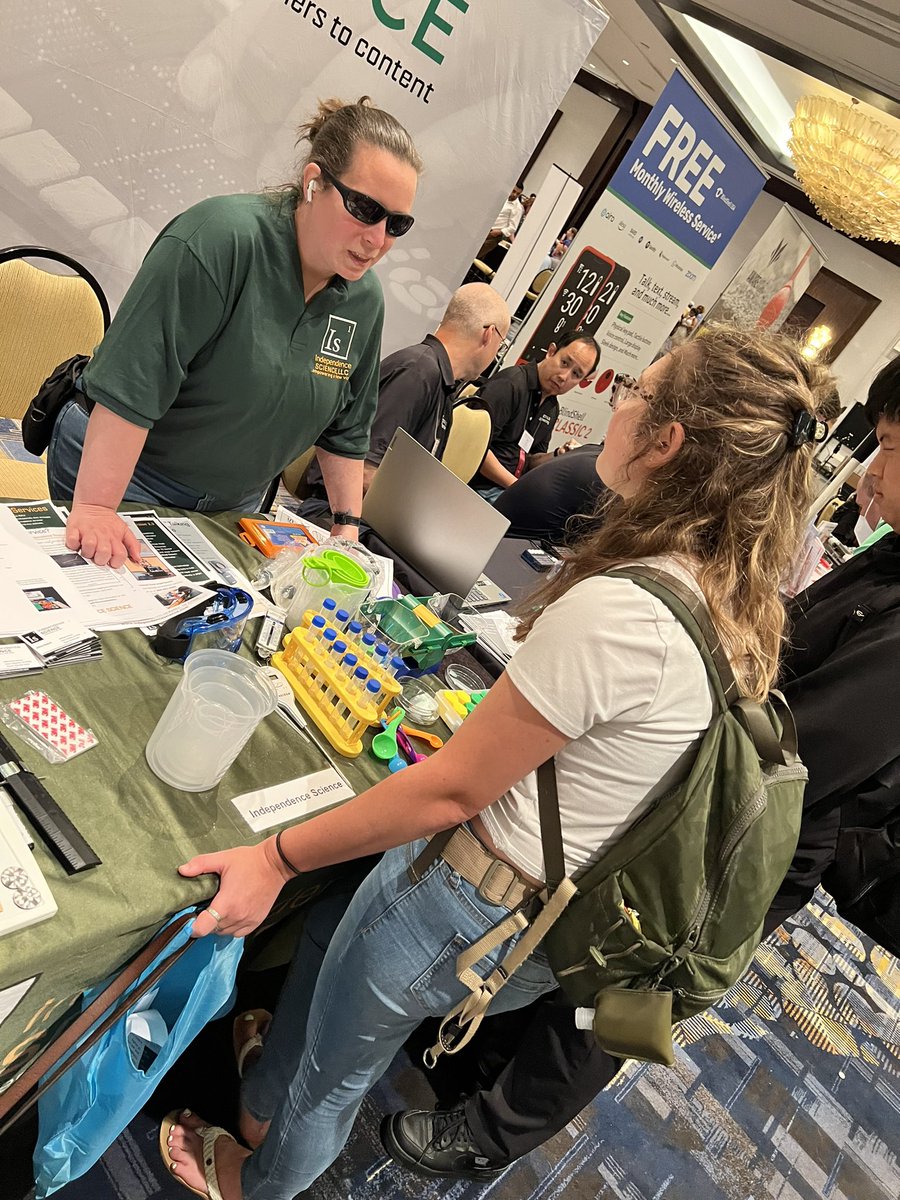 We are here until 5 today! Come check us out at B9 
#nfb2023 #indsci2023 #indscinfb2023 (image of our environmental scientist Charis talking to an environmental student). Many students are stopping by excited to ask our blind scientists many questions.