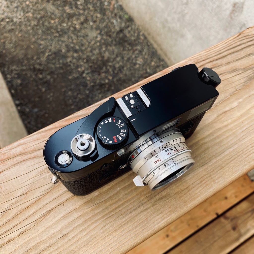 The bright violet flash of modern "MP" finder coating reveals that this Leica M7 A La Carte is a modern machine built in the 21st century. Black lacquer paint and the omission of any script on the top plate and the classic Leica Red Dot give this camera an understated look.