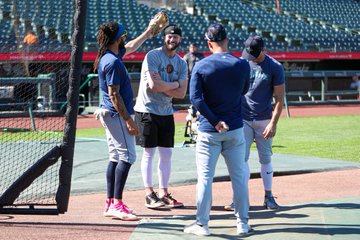 Photo of Mitch Haniger hanging out with J.P. Crawford, Dylan Moore and Jarred Kelenic during batting practice. 