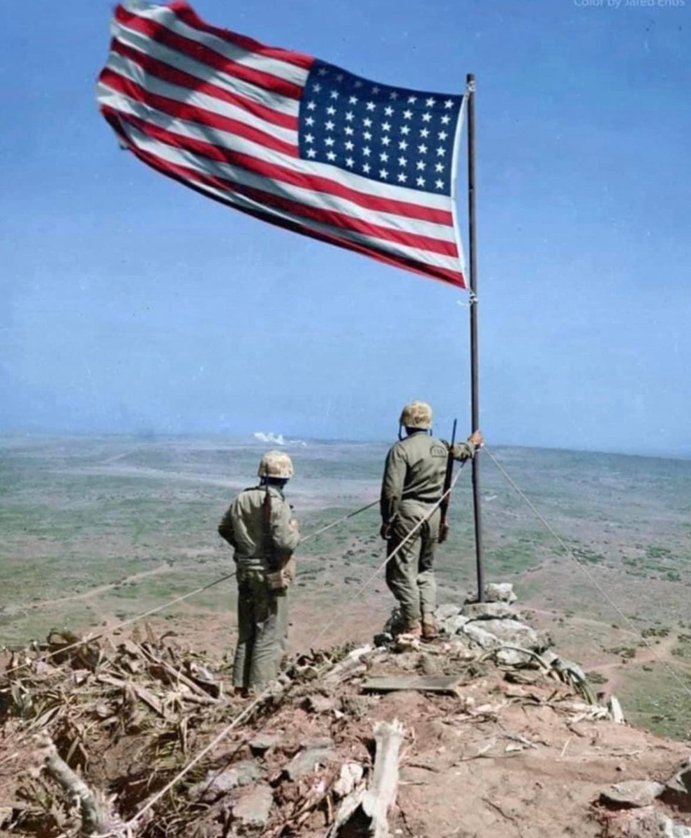 Jason_R_Burt's tweet photo. In February of 1945, two Marines look out over Iwo Jima from atop Mt. Suribachi, where two days prior, the US flag was raised. 🇺🇸 https://t.co/J2p6upewmM