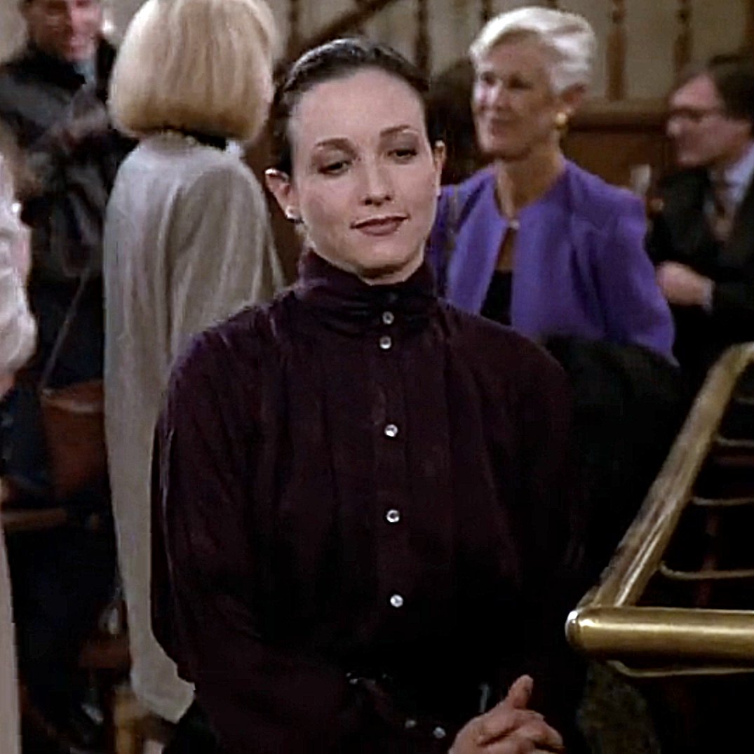 Bebe Neuwirth (Cheers S9E15 The Days of Wine and Neuroses 1991) #highcollar #highneck #highneckblouse #highcollarblouse #blouse #90sblouse #buttonedup #2buttoncollar #90sfashion #maroonblouse #tvshow #1991 #cheers #bebeneuwirth