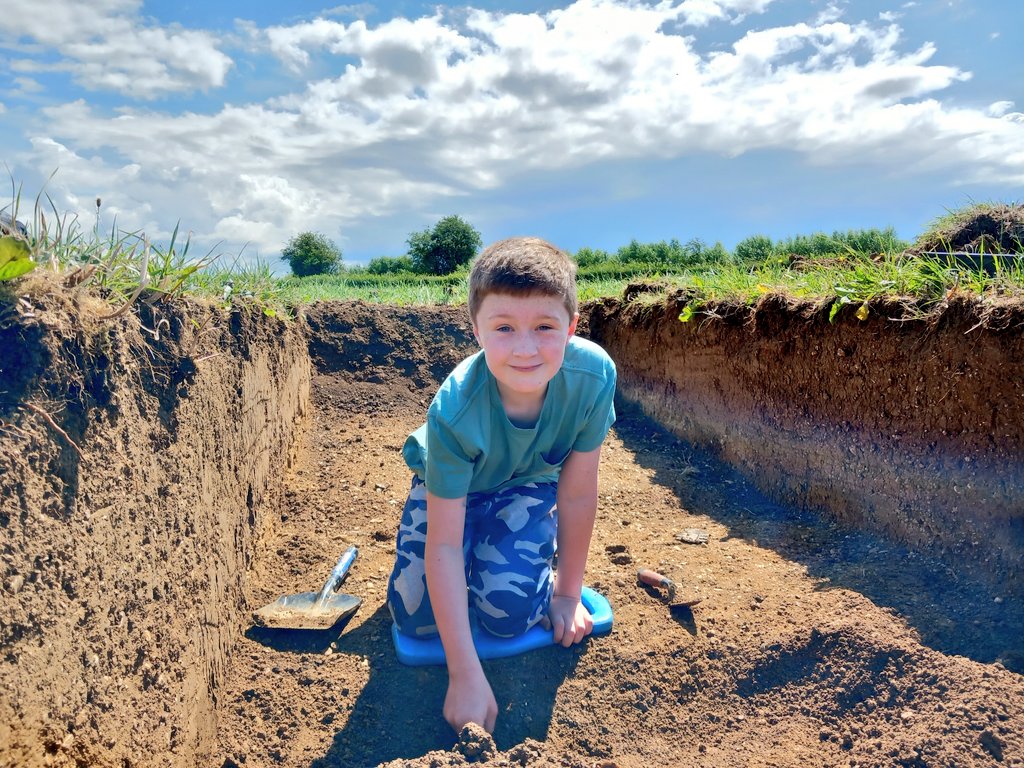 CotswoldArch's tweet photo. George and his Dad Chris have joined us today at #Kelmscottdig! They're in Trench 1 trying to get to the bottom of what looks like it might be a sizeable ditch. George has eagle eyes and has already spotted lots of animal bone amongst the fill! @KelmscottManor @SocAntiquaries https://t.co/mFKbxP1cj6