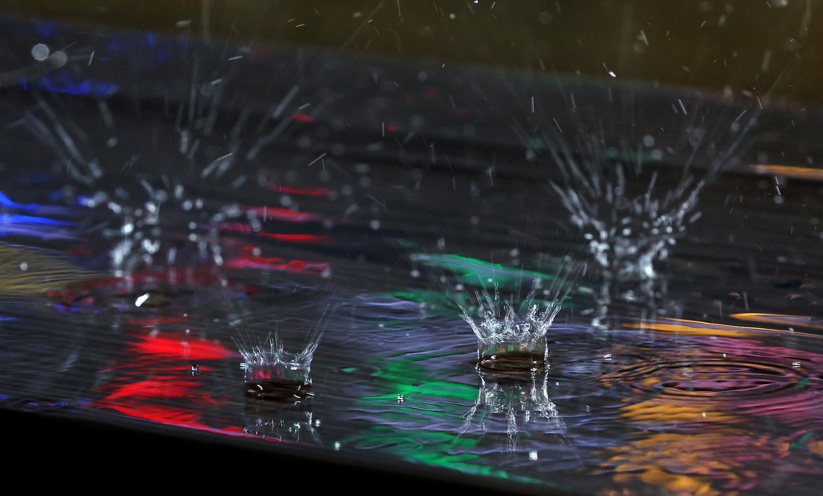 Colors from the Guaranteed Rate Field scoreboard are reflected in a puddle as rain falls during a delay before a scheduled game between the Chicago White Sox and the Toronto Blue Jays on Wednesday.  The game was eventually postponed with a doubleheader planned for Thursday.