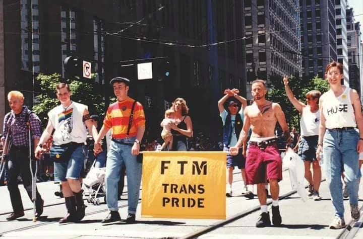 EliErlick's tweet photo. The first FTM contingent at San Francisco Pride (1994). From left to right: Max Wolf Valerio, Matt Rice, David Harrison, Loren Cameron, and an unknown marcher. Susan Stryker is in the back with a baby. https://t.co/43yCX7af24