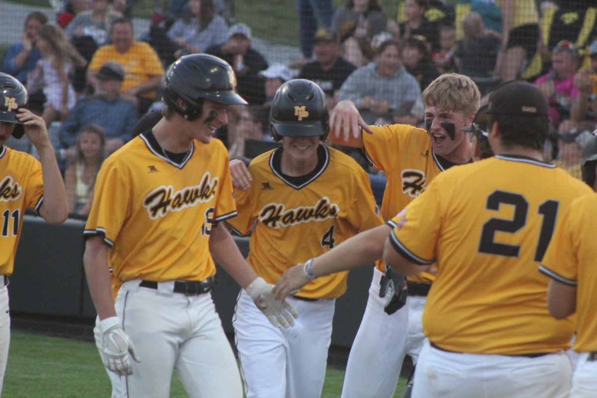 Joe Hall of Mid-Prairie is mobbed at home after his triple Wednesday night against Wilton turned into a three-run base-clearer. The Golden Hawks, ranked No. 2 in 2A, advanced to the District 9 title game with a 10-0 win. <a href="/TheNews_Sports/">The News — Sports</a> <a href="/GoldenHawkBball/">Mid-Prairie Baseball</a> <a href="/Mid_Prairie/">Mid-Prairie CSD</a>