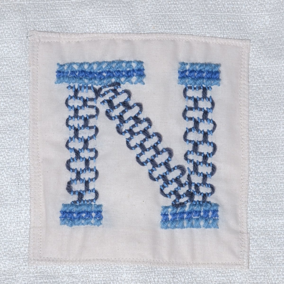 Inverkeithing Stitching in Time – 78th of 82 embroidery pieces. The artwork showcases images from Inverkeithing’s history. Like the artwork, we will showcase images of the amazing stitching talent, in chronological order 

N - by Liz Hunter