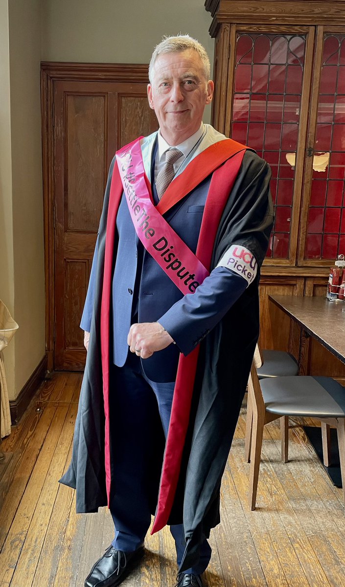 DrStuartHMoir's tweet photo. Getting prepared for my own graduation. Suit; check, Dr Gown; check, UCU picket armband; check, ‘settle the dispute’ sash; check, family looking on; check. Thanks to my Wife Tansy, couldn’t have completed an EdD without her support xox. https://t.co/TjyohqPscw