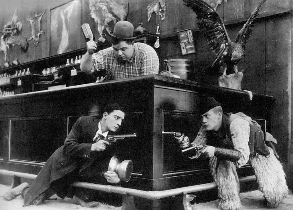 #RoscoeArbuckle about to hit #BusterKeaton who is holding a gun to #AlStJohn who is also pointing a gun at Buster! Who wins?! Find out in Out West (1918) Perfect weekend viewing! 

#Damfino #Comique #SilentCinema #SilentComedy #SilentHollywood #weekend #pub #drinking