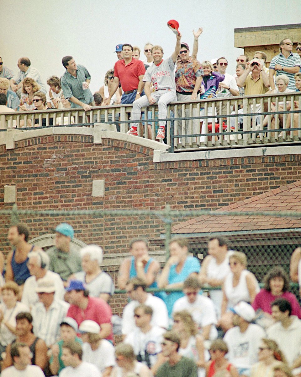 July 7, 1993: Tom Browning leaves the Reds' dugout at Wrigley Field in uniform, walks across the street and sits with a group of Cubs fans on the roof of an apartment building behind the right field bleachers. Manager Davey Johnson fines him $500 for the stunt. #RedsVault