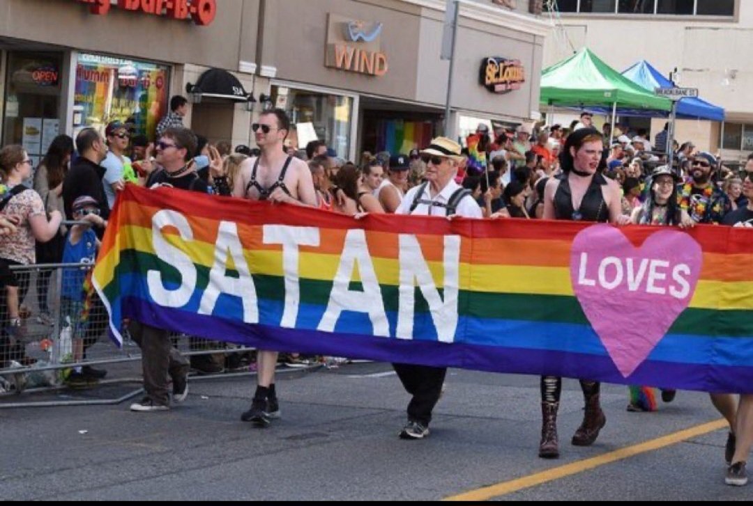 MartyCarnegie's tweet photo. A Pride parade banner. Just in case anyone is wondering, what's really behind the LGBT agenda. NOW YOU KNOW. It's not equality, it's demonic. https://t.co/LbCGZ7hWaB