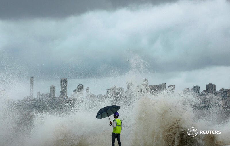 reuterspictures's tweet photo. A construction worker watches as waves crash at a coastal road construction site along the seafront, during high tide, in Mumbai, India. More photos of the day:  https://t.co/wdEFcAZkG8 📷 @Francispix https://t.co/eYbh4xmu3Y