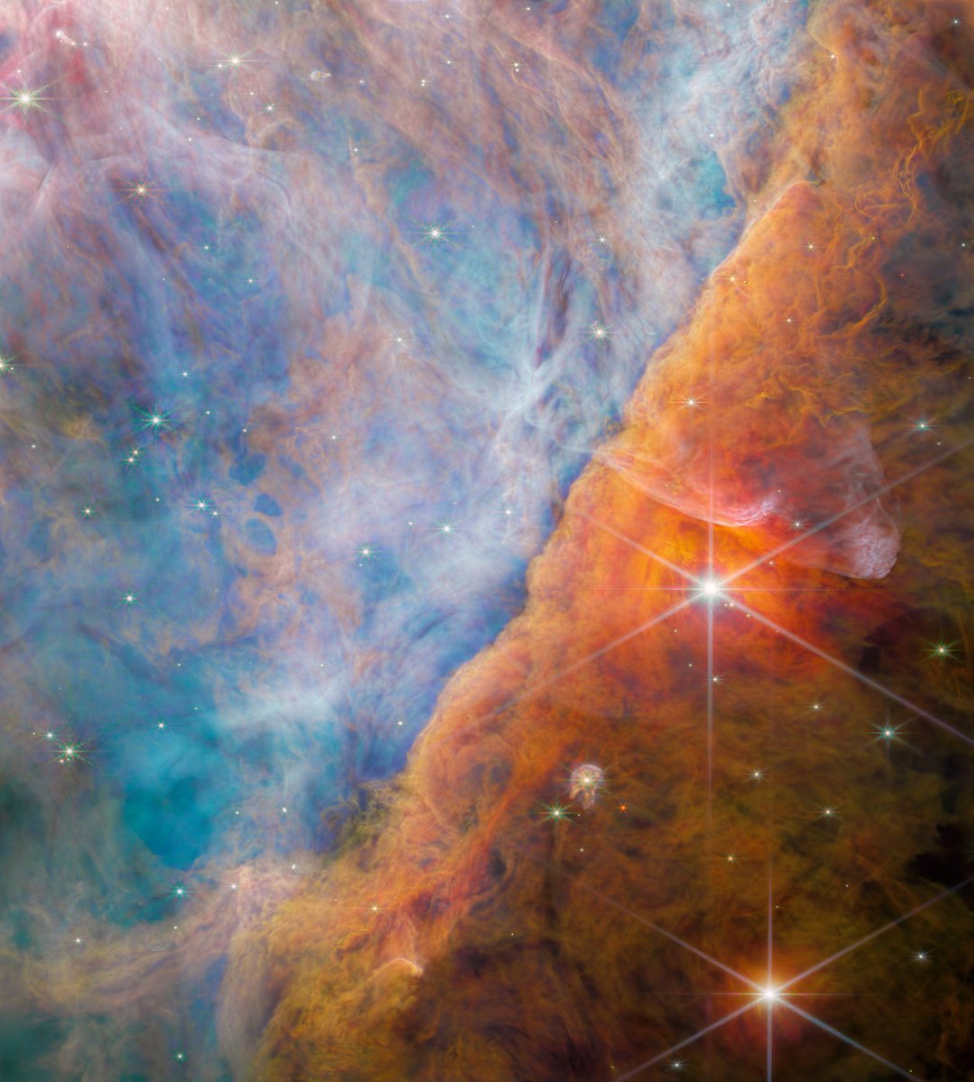 Juee Naik’s artwork is divided diagonally with blue on the left and orange on the right, just like Webb's view of the Orion Bar. This region of the Orion Nebula is where ultraviolet light from the Trapezium Cluster interacts with dense molecular clouds: go.nasa.gov/46Dntxu