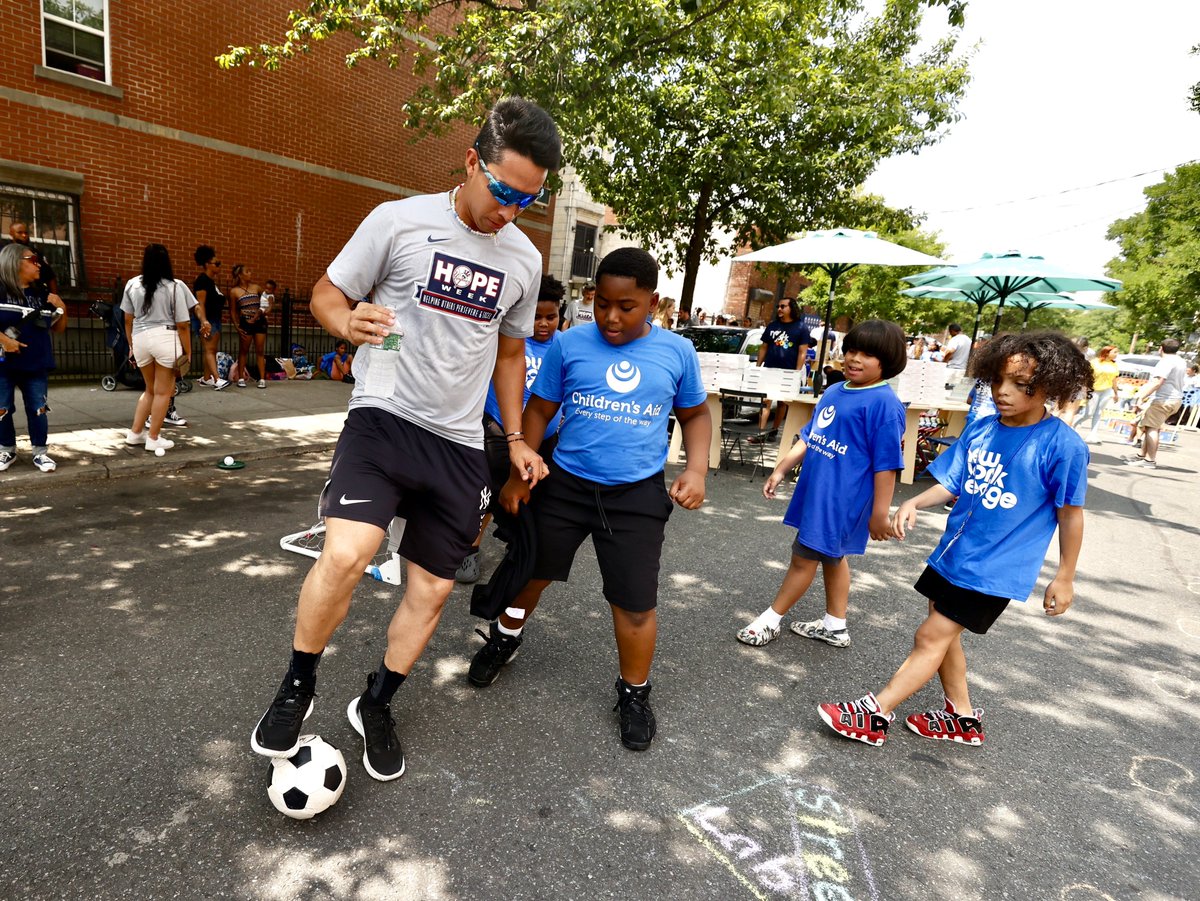 Yankees's tweet photo. On the 5th day of #HOPEweek, players surprised & played with local children from the Bronx in Street Lab’s open-street event.

@streetlab is a non-profit that creates temporary “pop-up” programs for city streets & public places in NYC. Street Lab’s goal is to improve the urban environment, strengthen neighborhoods, & bring New Yorkers together 💙
