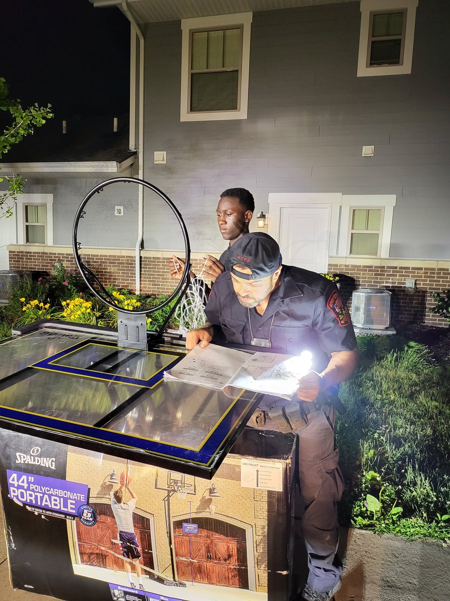 NCPD_Police's tweet photo. The North Chicago Police Department was patrolling the Brookstone Regency housing complex when a juvenile resident requested assistance in assembling a #basketball hoop. It took a team effort, and we were able to get it done. This is just one example of our #CommunityPolicing https://t.co/MjzEAHgzo6