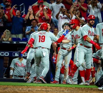 Photo of Cristian Pache being greeted by teammates at the dugout after hitting the go-ahead home run. The teammates are Kyle Schwarber, Trea Turner and Bryson Stott.