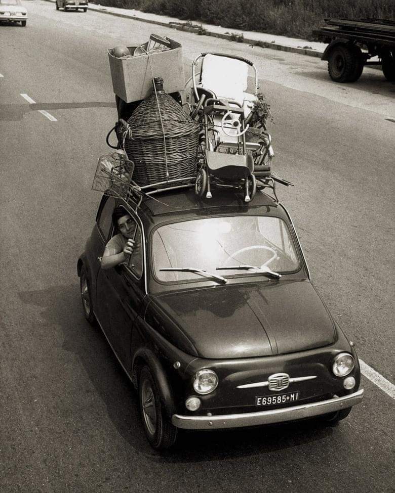 A family going on the summer holiday in a Fiat 500, Italy, 1967.