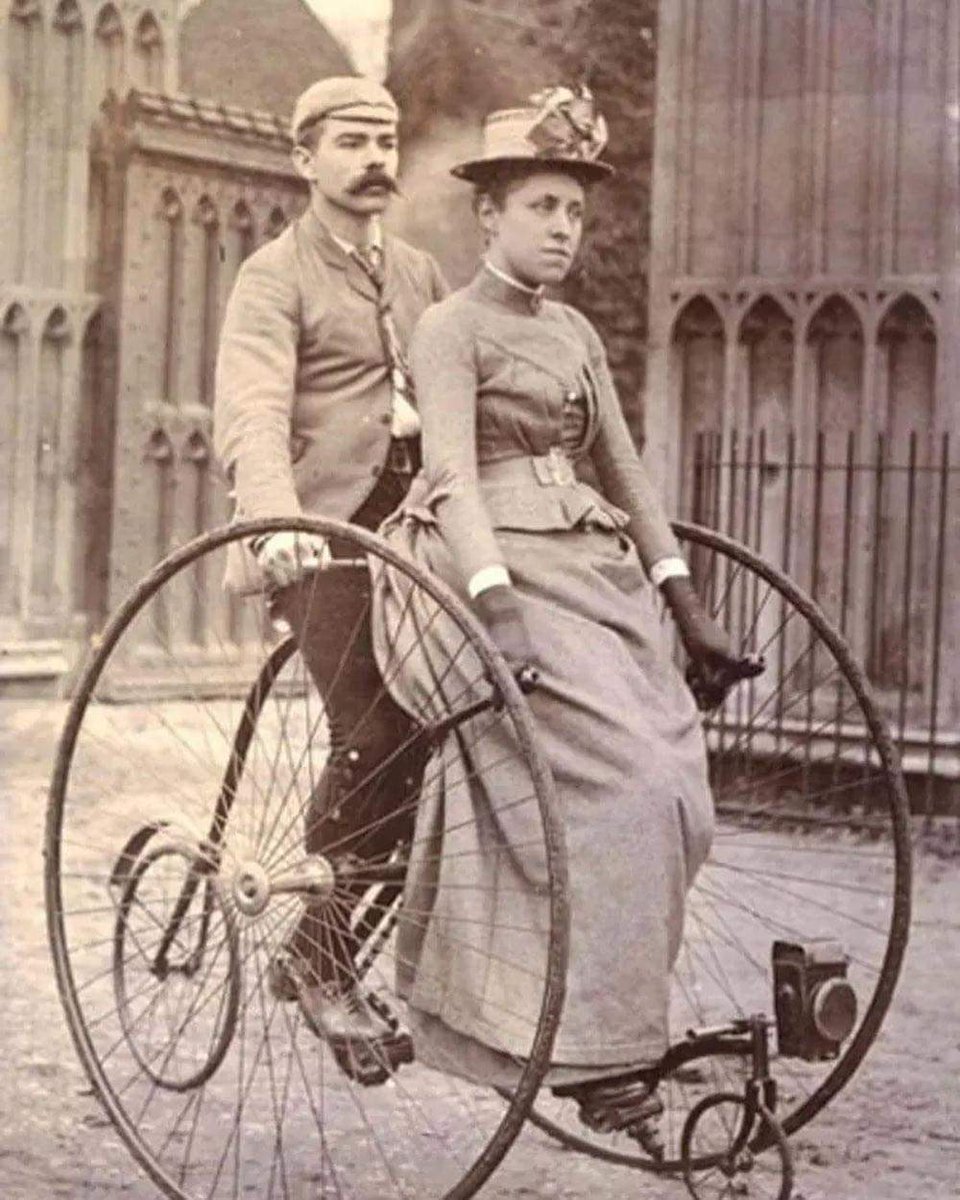 Victorian couple on a tandem bicycle, 1890s.