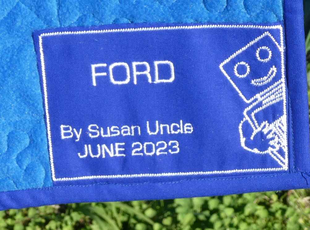 i made this for my friends husband. I pieced the quilt then quilted it and but then cause of the white fabric i used i had to appliqued the logo down