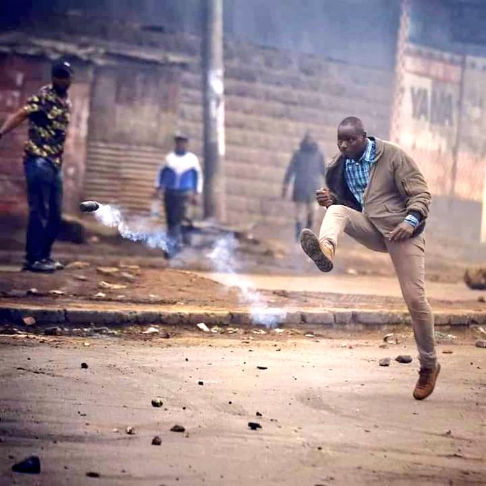 IMAGE: A Kenyan protester kicking back a teargas canister at security officers quelling protests in Kenya over hike in taxes and high cost of living.