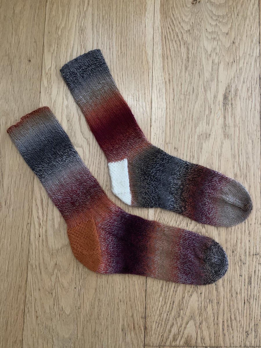 LivRunsFast's tweet photo. Getting KNIT done today! Fresh out the bath. My go-to ribbed socks in Zauberball crazy. Didn’t like how the heel interrupted the colour gradient, so used nearest contrast colour. Siblings, not twins. 
✅ June socks #sockalong #KnittingTwitter #KnitYourStash https://t.co/smnBjNowqY