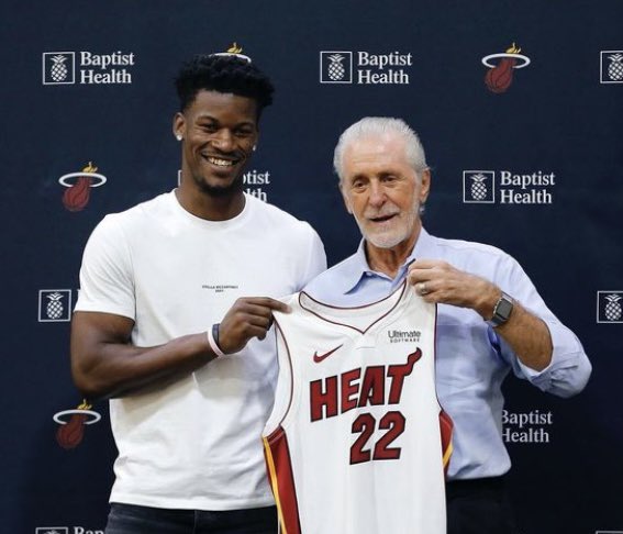 Jimmy Butler and Pat Riley: Holding up Heat jersey.