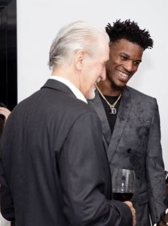 Pat Riley and Jimmy Butler: Laughing, looking down.