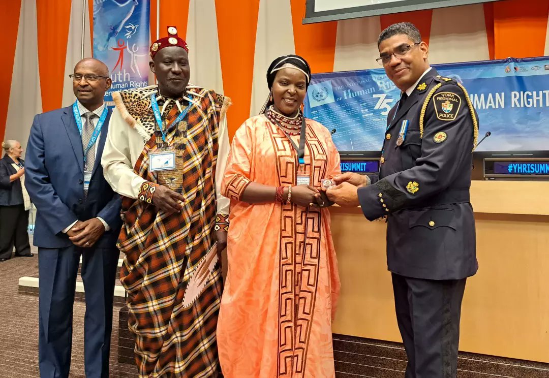 network_aido's tweet photo. *New York City* 
HH.Paul Eganda  and Queen Grace Eganda, on behalf of AIDO, received the badge of honour from the York Regional police inspector at the United Nations . https://t.co/HGuLJP9Etn