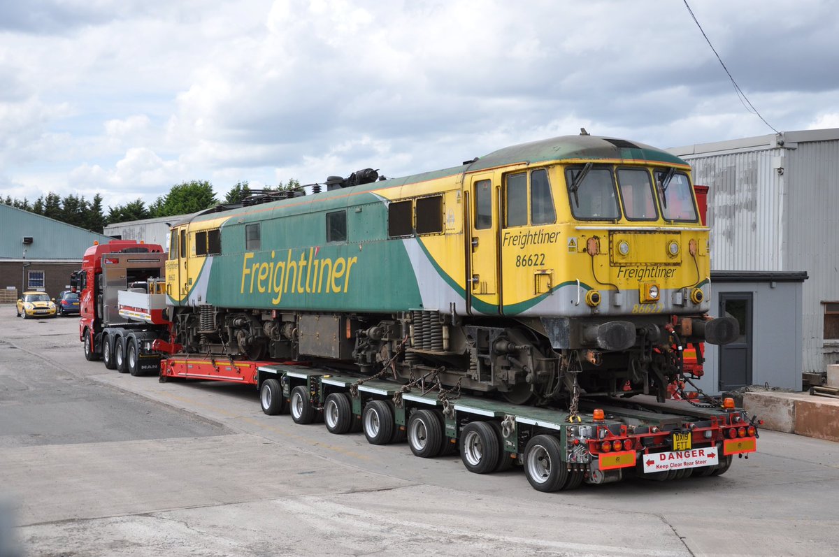 The stored former <a href="/RailFreight/">Freightliner</a> 86s that are stored at Crewe are being prepared for export to Bulgaria. Reid Freight are set to move all to Immingham by road, with up to three movements a week. 86622, the first to move, is seen in Reid’s Longton yard today en route.📷 Cliff Beeton