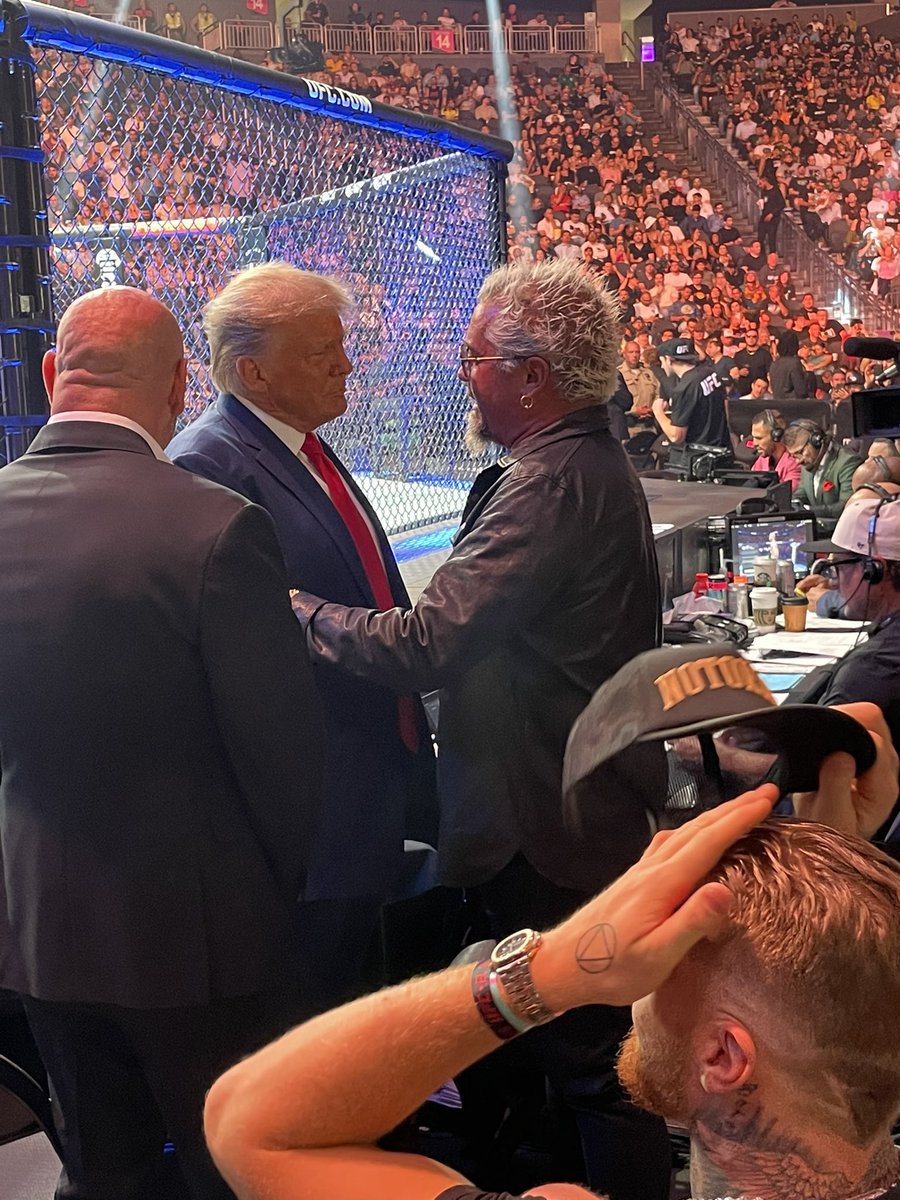 PopCrave's tweet image. Guy Fieri greeting criminal defendant Donald Trump at UFC 290 in Las Vegas.