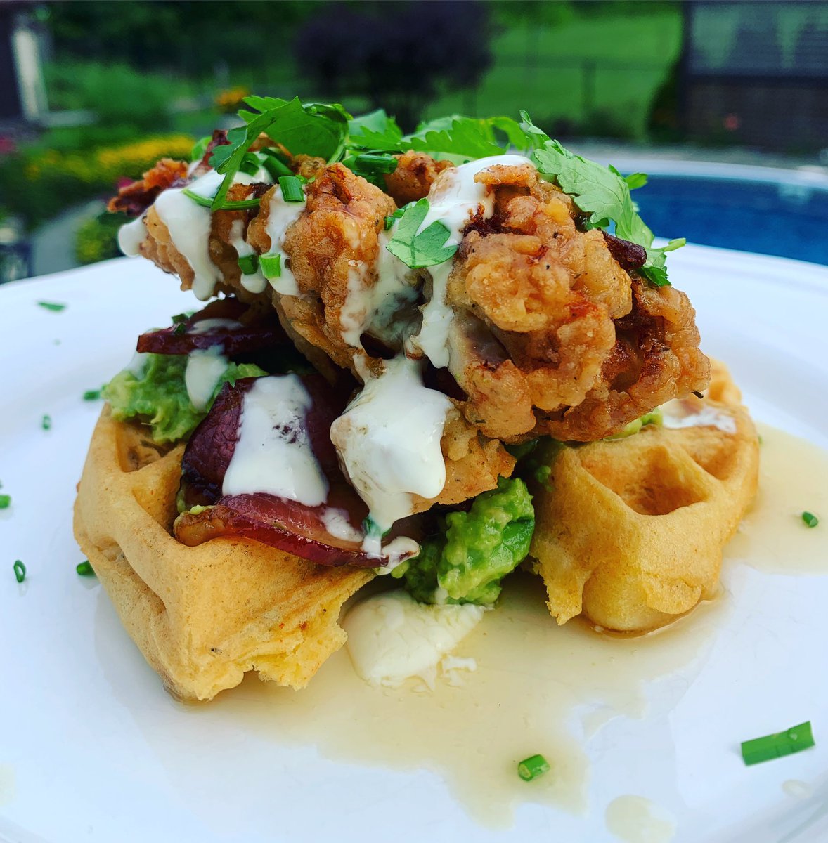 Birthday dinner for my daughter.  She wanted chicken and waffles.  Made this savoury waffle with roasted red peppers and chives and topped with a chunky guacamole, maple-candied bacon and garlic sauce with cilantro.  #foodie #chickenandwaffles  #savory