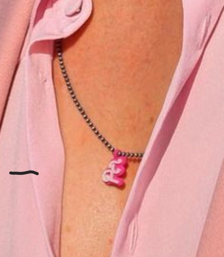ryan gosling rocking not just a sexy little chain but a sexy little chain with a barbie font E for EVA on it I’m gonna throw myself off a cliff
