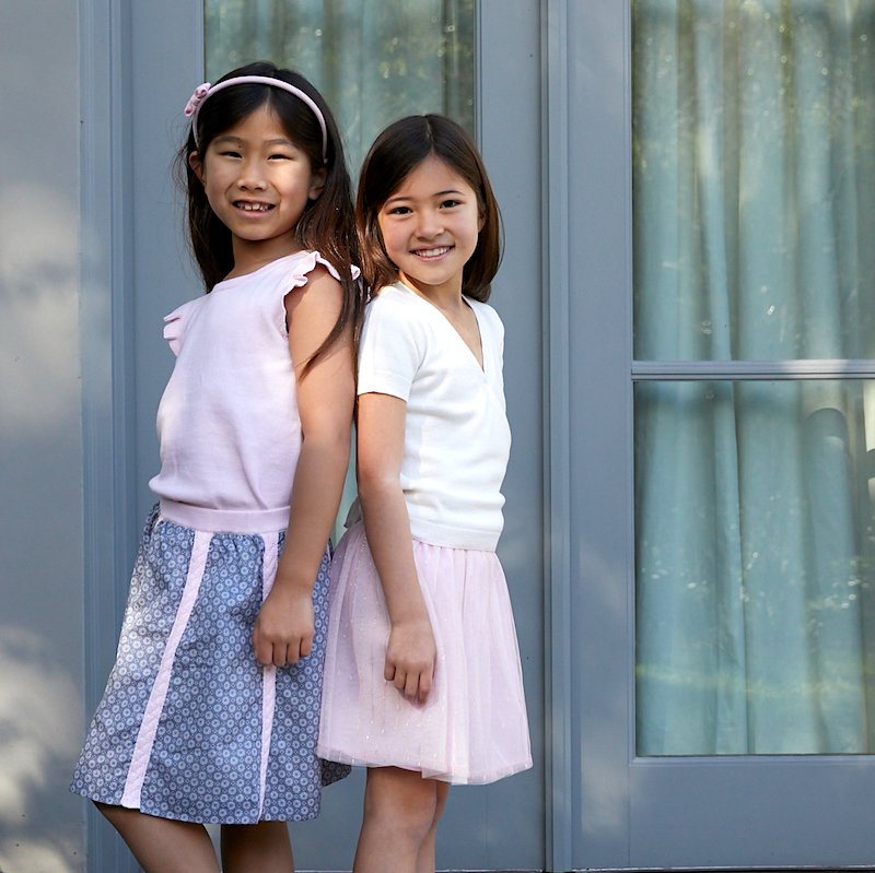#Summer in full swing 😎These two #cuties having #fun in the sun ☀️Miss E wears our Genevieve flutter top + Celeste #skirt. Miss M wears our Marina wrap cardigan + Gemma tulle skirt 💗💙💗💙 100% #cotton knit + textiles, 100% #adorable! edenandzoe.com/collections/gi… #kids #fashion