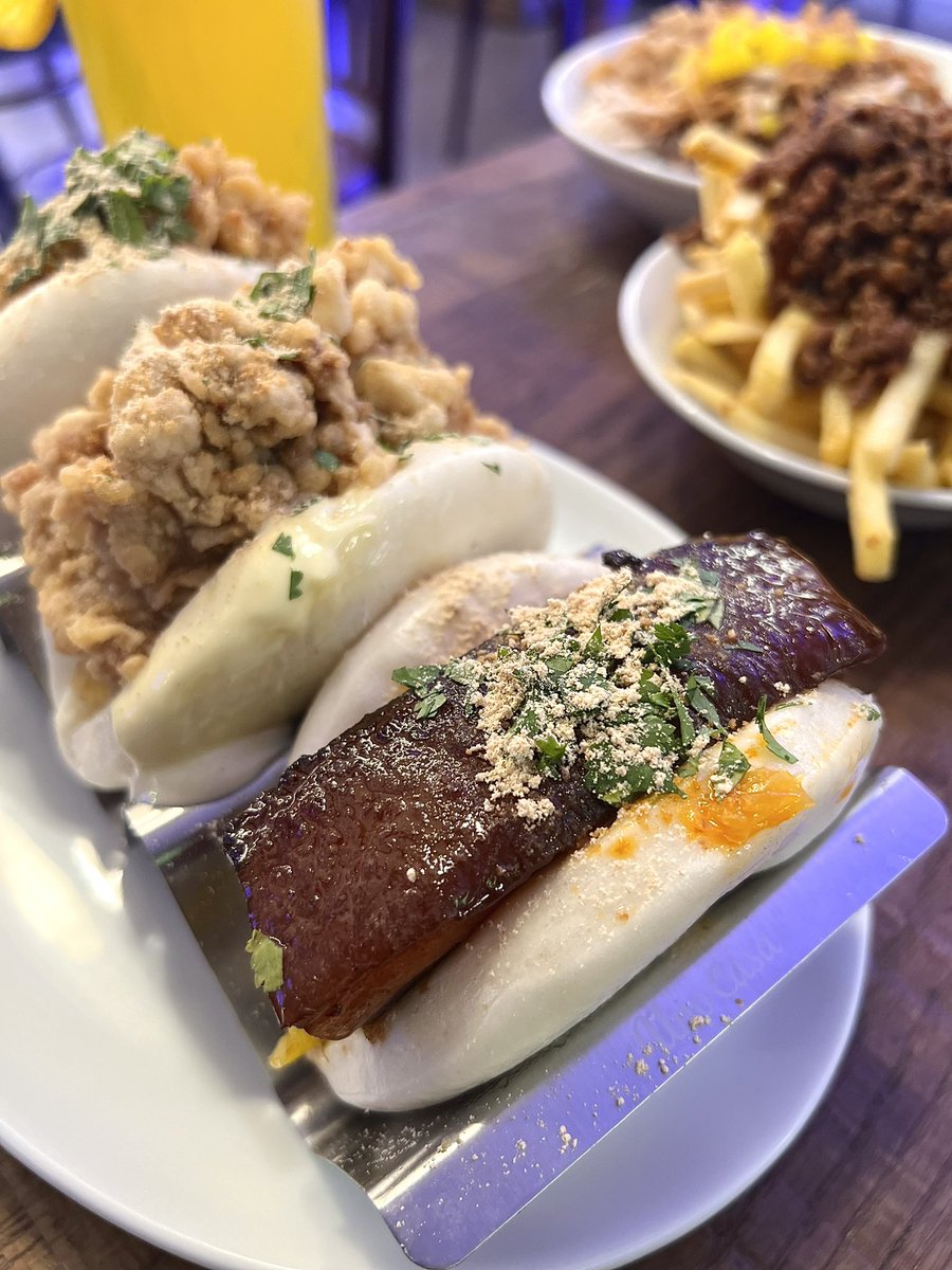 stephbrookes's tweet photo. A gluttonous visit to Baohaus in Islington, and I *had* to over order knowing that the residency is only on until the end of August! A feast of  braised pork and chicken baos, as well as stew over fries and a umami-rich rice bowl of poached turkey, pork and crispy chicken 😍 https://t.co/HJhpq2ukZY