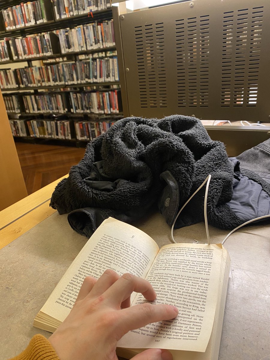 Is it forbidden to read a book I own in a library with many books I do not own