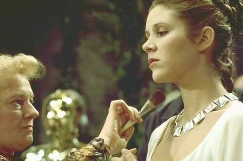A behind the scenes photo of  Carrie Fisher with her make-up artist applying the finishing touches for the medal ceremony scene in STAR WARS (1977). https://t.co/QmLzzVakBY